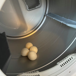 Four wool dryer balls sitting in an empty dryer